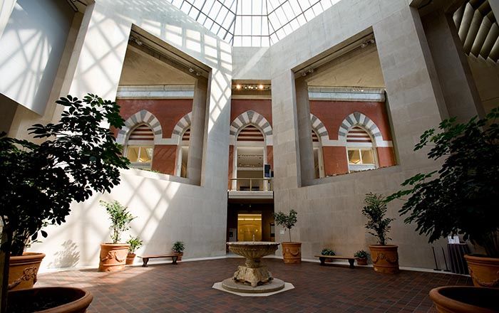 A small, sunlit, two-story octagonal interior courtyard in the middle of the Museum wing for the Robert Lehman Collection